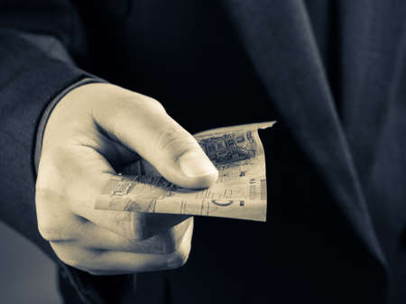 Closeup hand offering money for somethingの写真素材