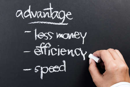 Hand writing a competitive advantage of business concept with chalkの写真素材