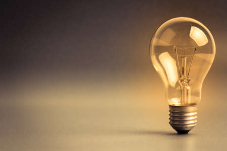 Single light bulb, still life as symbol of idea with copy space