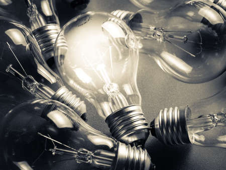 One light bulb shining in the darkness, monotone color