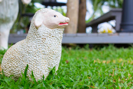 Ceramic sheep doll decorated in the gardenの写真素材