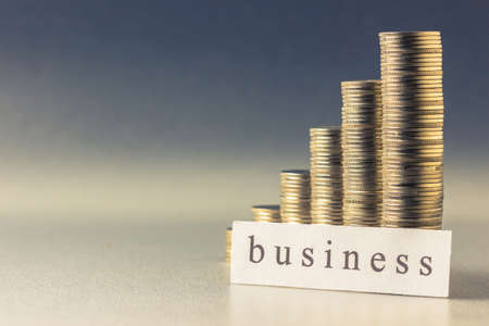 Coins heap stair with Business topic printed on paperの写真素材