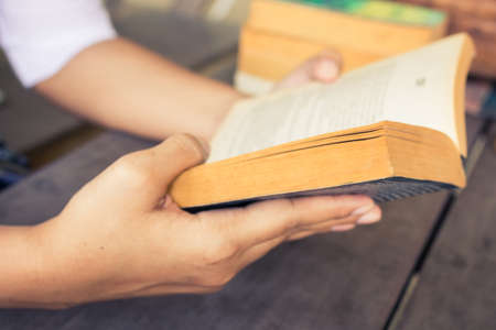 Closeup hand  holding pocket book to readの写真素材