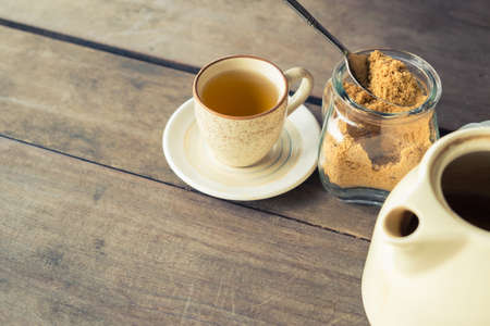 Cup of tea with brown sugar and teapot, retro color style