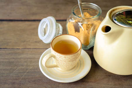 Cup of tea with brown sugar and teapot, retro color style