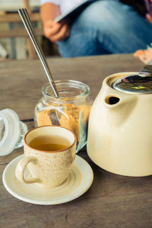 Cup of tea with brown sugar and teapot, retro color style