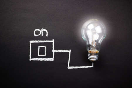 Glowing light bulb with drawing switchの写真素材