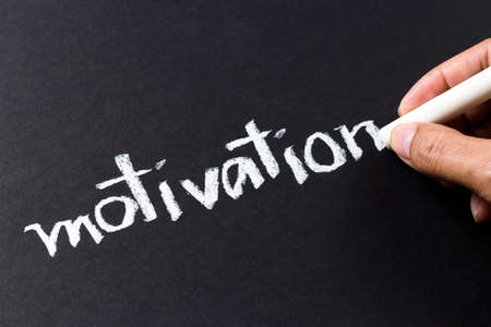 Hand writing Motivation word with chalkの写真素材