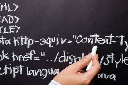 Hand writing computer source code with chalk