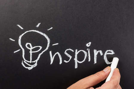 Hand drawing light bulb as symbol of Inspire word