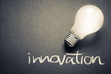 Glowing light bulb with Innovation wordの写真素材