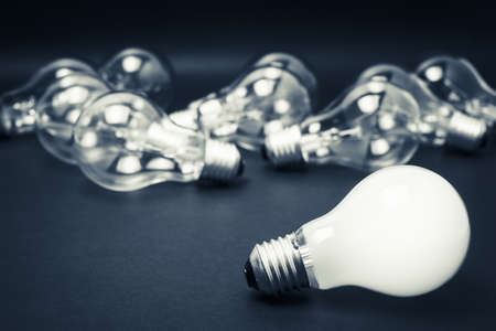 White light bulb glowing among the others, leadership, idea, finally success after many tests was failedの写真素材