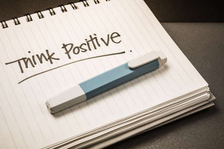Handwriting of Think Positive word as memo note on spiral notebookの写真素材