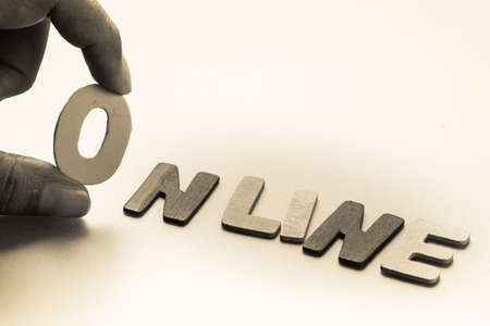 Closeup finger pick an English letter of On Line wordの写真素材