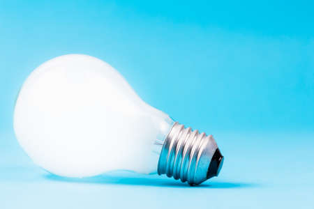 White light bulb on blue background