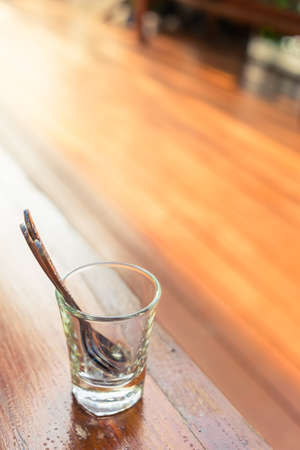Teaspoon in small glass at wood terrace with copy spaceの写真素材