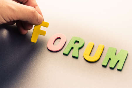 Finger pick a wood letters of Forum word