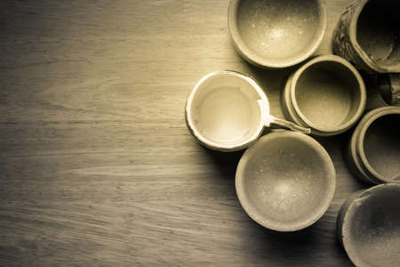 Old earthenware on wood tableの写真素材