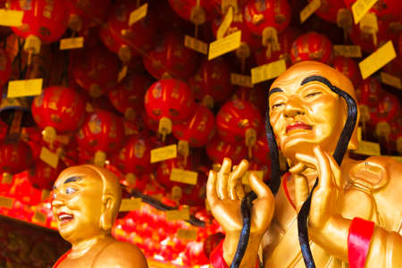 Gold priest statue in Chinese templeの写真素材