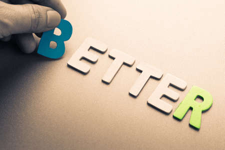 Hand arrange wood letters as Better wordの写真素材