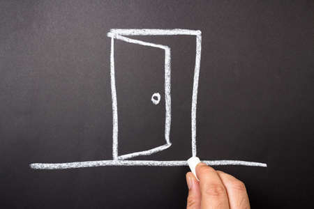 Hand drawing opened door with chalkの写真素材