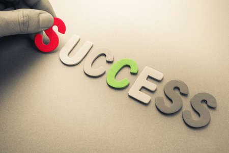 Hand arrange wood letters as Success wordの写真素材