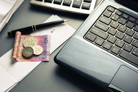 Money on bills with laptop and calculator