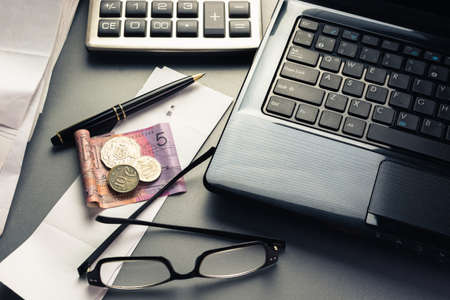 Money on bills with laptop and calculator