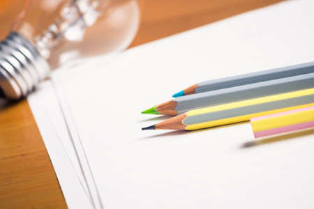 Pencils on papers with light bulb, creative writing conceptの写真素材