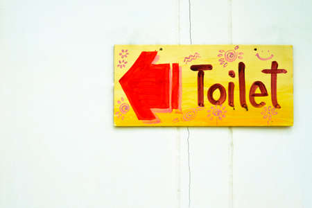 Wood toilet sign on old white wallの写真素材