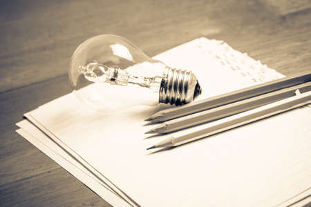 Pencils on papers with light bulb, creative writing concept