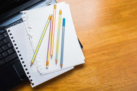Pencils and papers on laptop, communication writing concept