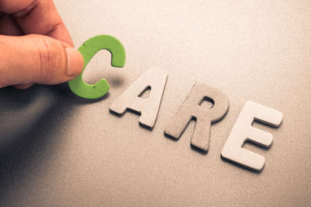 Hand arrange wood letters as Care Wordの写真素材