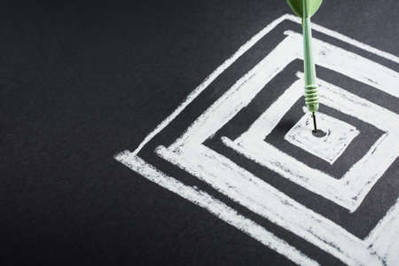 Dart hit the center of square dartboardの写真素材