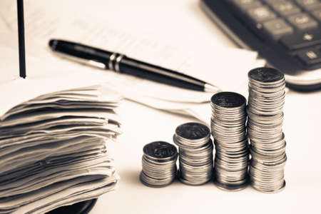 Increase sales, heap coins stair with pile of receipts in paper nail