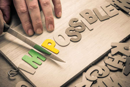 Hand cut wood letters on chopping board as Possibility conceptの写真素材