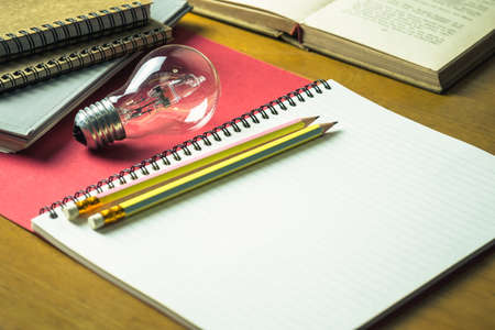 Pencils and light bulb on notebook for creative writing conceptの写真素材