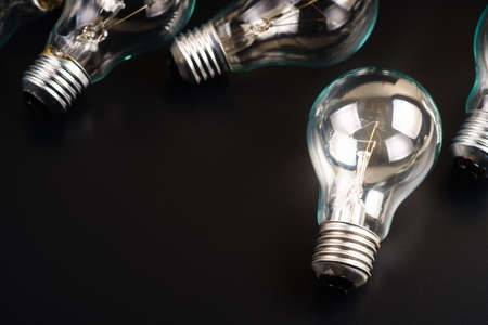 Light bulbs glowing on black backgroundの写真素材