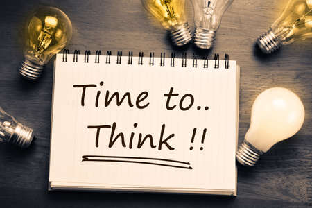 Time To Think, handwriting on notebook with light bulbsの写真素材