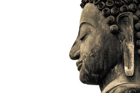 Ancient Buddha face statue in Sukhothai Historical Park of Thailand isolated on white backgroundの写真素材