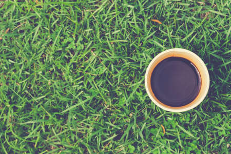 Cup of black coffee on grassesの写真素材