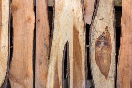 Cut wood plank arranged in pattern as wallの写真素材