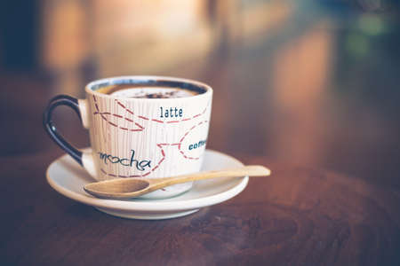 Cup of cappuccino with wood spoon, retro color style