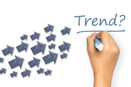 Hand writing Trend topic with many paper arrows as symbolの写真素材