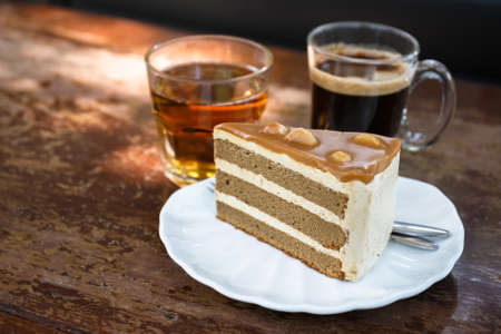 Milk tea cake with coffee and tea on wood tableの写真素材