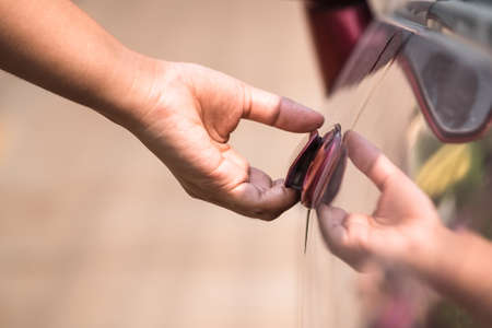 Closeup hand going to open car doorの写真素材