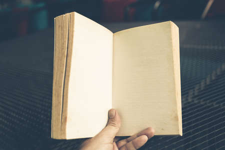 Hand open blank page of pocket book with one hand, retro style colorの写真素材