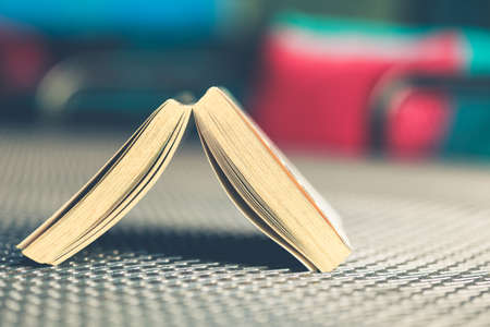 Opened pocket book place upside down on the metal wire surface tableの写真素材