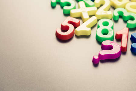 Plastic question mark and numbers on the tableの写真素材