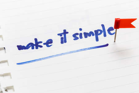 Make It Simple text as memo on notebook with flag push pinの写真素材